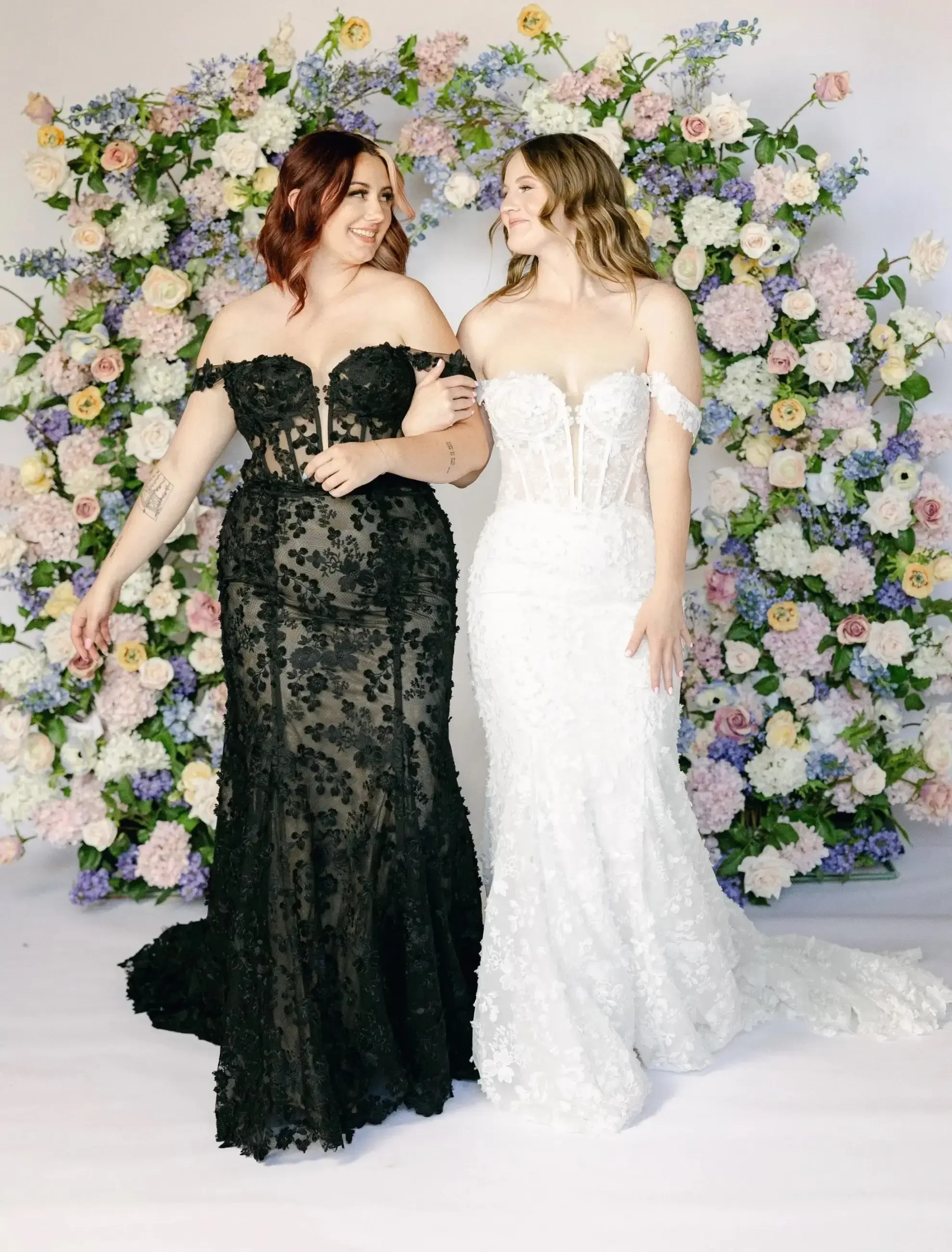 models wearing black and white wedding gowns