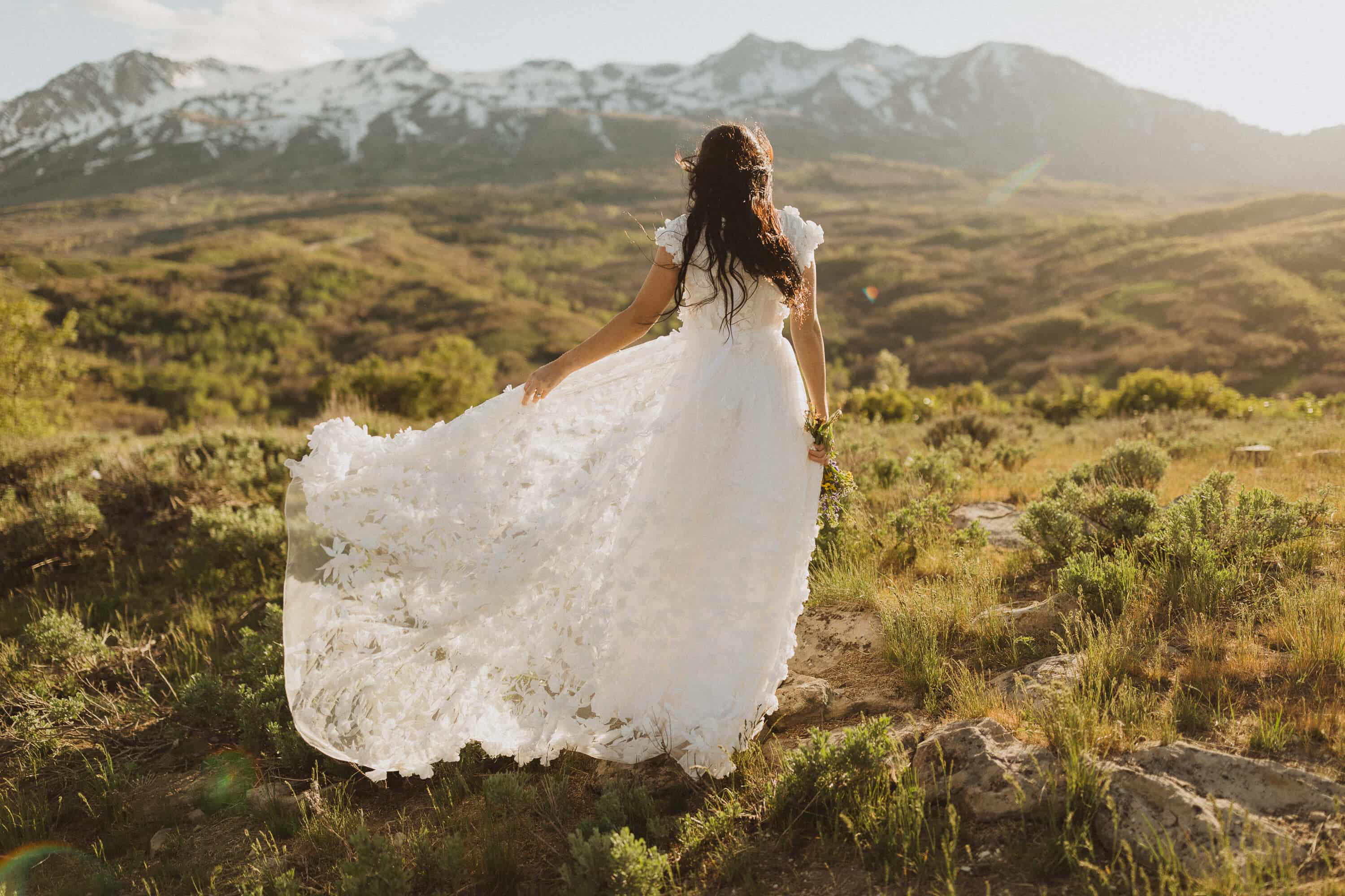 Bride and groom in white wedding dress and tux at sunset
