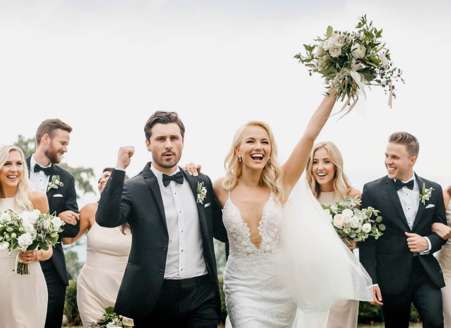 Bridal party with bride, groom, bridesmaids in formal wear