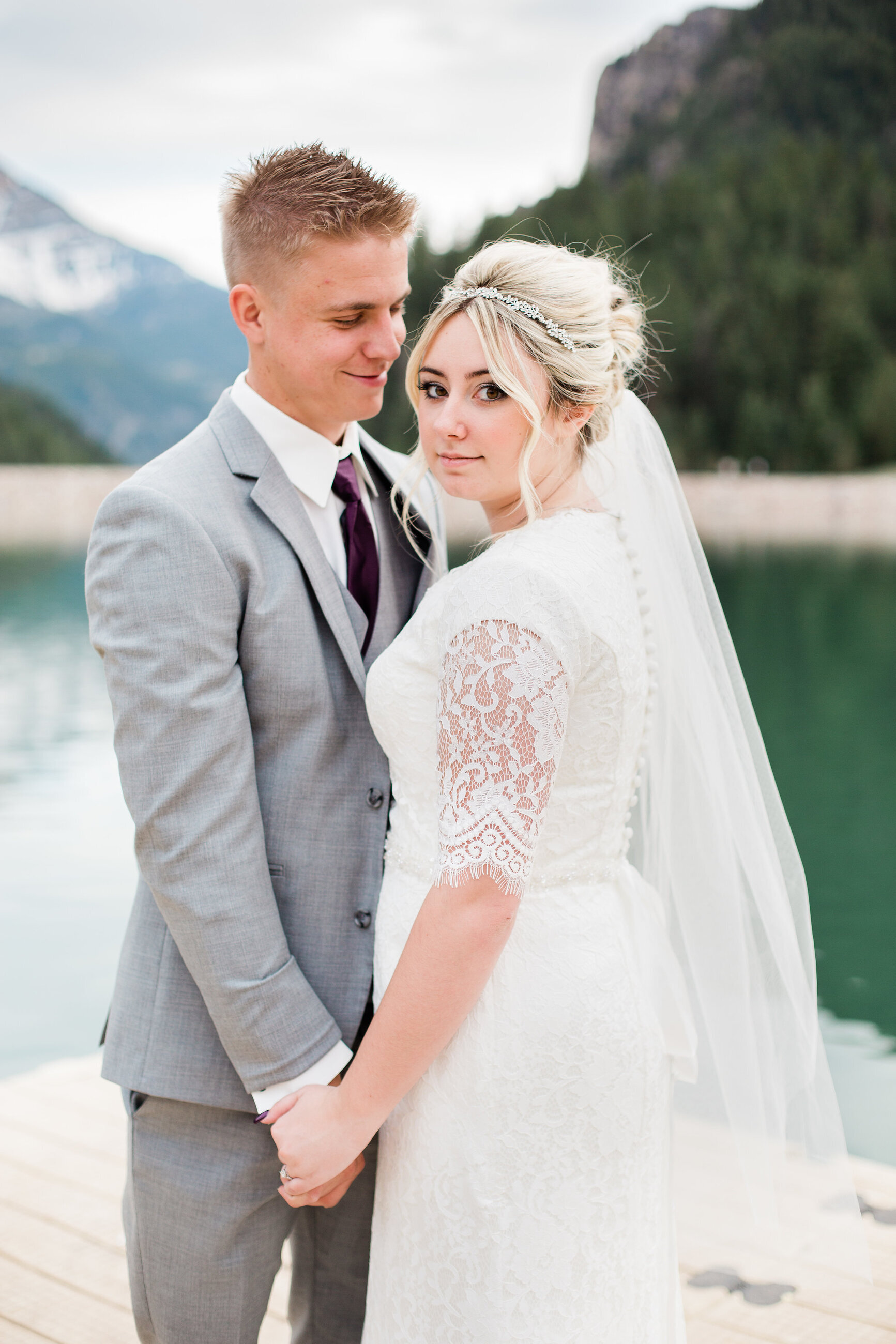 Сouple wearing a white gown and a gray suit